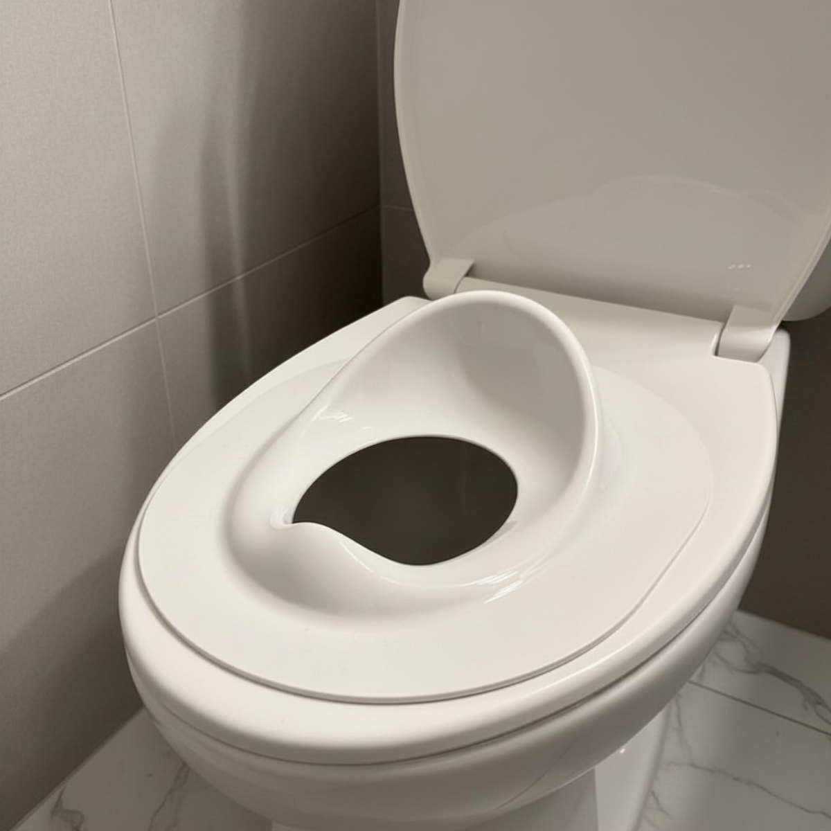 Tot Perch toddler toilet seat insert — close-up of quick-use position on closed toilet seat